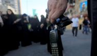 Hezbollah member holds a wireless communication device with its battery removed after a wireless communication device exploded during a funeral, in Beirut, Lebanon, on Sept. 18, 2024. (Xinhua/Bilal Jawich)
