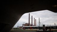 An RB (Regional railway) train leaves the main railway station in front of the power plant at the headquarters of German carmaker Volkswagen (VW) on September 25, 2024 in Wolfsburg, northern Germany. Photo by RONNY HARTMANN / AFP