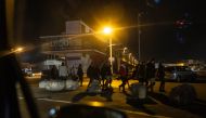 Photo used for demonstration purposes. Migrants walk as they prepare to attempt a crossing of the English Channel near the beach of Boulogne-sur-Mer, northern France on September 21, 2024. Photo by Sameer Al-DOUMY / AFP.