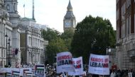 Pro-Palestinian activists and supporters wave flags and hold placards as they pass through central London, during a March for Palestine on October 5, 2024. Photo by JUSTIN TALLIS / AFP.
