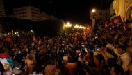 Supporters of Tunisia's President celebrate after the announcement of the first estimates in favor of the incumbent President, during Tunisia's Presidential election, on the Avenue Habib Bourguiba in Tunis on October 6, 2024. (Photo by YASSINE MAHJOUB / AFP)
