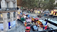 This photo taken on October 15, 2024 at the corner of Boulevard Malesherbes and rue Boissy d'Anglas near The Madeleine church shows first responders and police at the scene after a cyclist was run over by a SUV in Paris. (Photo by Veronique Lagarde / AFP)