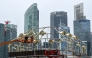 File photo of workers assembling a structure near the financial business district in Singapore.