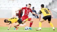 Al Arabi's Marco Verratti (centre) vies for the ball possession with two Al Qadsia players during yesterday's match. 