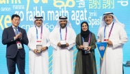 Qatar Gymnastics Federation President and FIG First Vice President Ali Al Hitmi (right) and FIG President Morinari Watanabe (left) pose for a picture along with other officials.