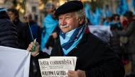 A protester holds a copy of the monthly 