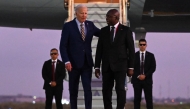 US President Joe Biden (3rd R) walks on the red carpet next to Angola Foreign Affairs Minister Tete Antonio (2nd R) upon his arrival at the Quatro de Fevereiro Luanda International Airport in Luanda on December 2, 2024. (Photo by ANDREW CABALLERO-REYNOLDS / AFP)
