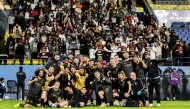 Al Sadd players celebrate their victory.