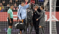 Real Madrid's French defender 23 Ferland Mendy (C) leaves the pitch after resulting injured during the Spanish league football match between Girona FC and Real Madrid CF at the Montilivi stadium in Girona on December 7, 2024. (Photo by Josep LAGO / AFP)

