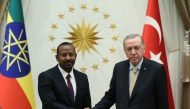 This handout photograph taken and released by the Turkish presidential press service on December 11, 2024, shows Turkish President Recep Tayyip Erdogan (right) greeting Ethiopia's Prime Minister Abiy Ahmed at the Presidential Palace in Ankara. Erdogan greet Ethiopia and Somalia leaders in Ankara. (Photo by Turkish Presidental Press Service /AFP
