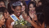 Newly elected Miss France 2025 Angelique Angarni-Filopon celebrates winning the Miss France 2025 beauty pageant, on December 14, 2024. (Photo by Romain Perrocheau / AFP)