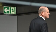 German Chancellor Olaf Scholz is pictured next to an exist sign during a vote of confidence against himself in a plenary session at the Bundestag (Lower house of Parliament) in Berlin on December 16, 2024. (Photo by RALF HIRSCHBERGER / AFP)
