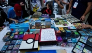 (Files) People trade Pokemon cards during the first day of the 2019 Pokemon World Championships at the Washington Convention Center August 16, 2019, in Washington, DC. (Photo by Brendan Smialowski / AFP)