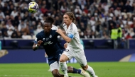 Pachuca's Ecuadorian defender #33 Andres Micolta and Real Madrid's Croatian midfielder #10 Luka Modric vie for the ball during the 2024 FIFA Intercontinental Cup final football match between Spain's Real Madrid and Mexico's Pachuca at the Lusail Stadium in Doha on December 18, 2024. (Photo by KARIM JAAFAR / AFP)