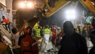 Emergency and rescue teams work at the site where a concrete outdoor roof of a train station collapsed in the northern Serbian city of Novi Sad on November 1, 2024. Photo by NENAD MIHAJLOVIC / AFP


