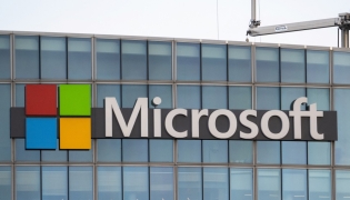 This photograph shows a view of Microsoft's logo on the company's French headquarters in Issy-les-Moulineaux on the outskirts of Paris on January 6, 2025. (Photo by Martin LELIEVRE / AFP)