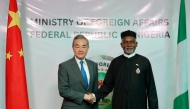 Chinese Foreign Minister Wang Yi (L) shakes hands with Nigeria's Foreign Affairs Minister Yusuf Tuggar (R) during Minister Wang's diplomatic visit to Abuja on January 9, 2025. (Photo by Kola Sulaimon / AFP)
