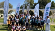 The medal winners pose for a photo with officials.
