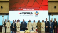 Cluster Chief Executive Officer of Elegancia Services—a subsidiary of Estithmar Holding, Abd Almunem Al Sakka and Commercial Director at Qatar Primary Materials Company, Abdullah Hassan Al Kuwari with other officials during the signing of MoU.