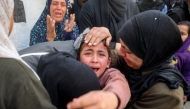 The young sister (C) mourns for her siblings and other members from the Abu al-Rous family who were killed when their house was hit by Israeli bombardment, during the funeral at the Bureij camp for Palestinian refugees in the central Gaza Strip on March 25, 2025. Photo by Eyad BABA / AFP