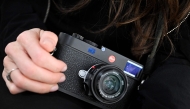German photographer Franziska Stuenkel holds an M11 Leica camera during an interview with AFP in Frankfurt am Main, western Germany, on March 28, 2025. Photo by Kirill KUDRYAVTSEV / AFP