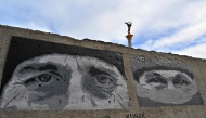 This photograph shows graffitis depicting fallen Ukrainian servicemen, painted by street artists at the Independence Square in Kyiv on April 19, 2025, amid the Russian invasion of Ukraine. Russian President Vladimir Putin on April 19 announced a surprise Easter truce in the conflict in Ukraine to last until midnight on April 20. (Photo by Sergei SUPINSKY / AFP)