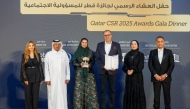 Officials pose for a group photo during the Qatar CSR Awards 2025 held at The Ritz-Carlton.