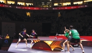 China's Wang Chuqin (left) and Sun Yingsha (second left) compete against Hugo Calderano and Bruna Takahashi of Brazil.