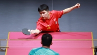 China's Lin Shidong hits a return during the men’s singles round of 64 match against Lam Siu Hang. Pictures: Xinhua