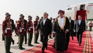 This handout picture provided by the Iranian presidential office shows Iran's President Masoud Pezeshkian (front C) being received by Oman's Sultan Haitham bin Tariq al-Said (front R) during a welcome ceremony at the airport in Muscat on May 27, 2025. (Photo by Iranian Presidency / AFP)