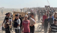Displaced Palestinians receive food packages from a US-backed foundation pledging to distribute humanitarian aid in western Rafah in the southern Gaza Strip on May 27, 2025. (Photo by AFP)