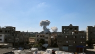 Smoke billows in the background during an Israeli strike, as pictured from the Nuseirat refugee camp in the central Gaza Strip, on May 29, 2025. (Photo by Eyad Baba / AFP)