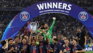 Paris Saint-Germain's Brazilian defender #05 Marquinhos lifts the trophy as he celebrates with teammates winning the UEFA Champions League final football match between Paris Saint-Germain (PSG) and Inter Milan in Munich, southern Germany, on May 31, 2025. (Photo by FRANCK FIFE / AFP)