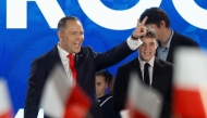 Karol Nawrocki, candidate for the 2025 Polish presidential election supported by Poland's right-wing Law and Justice (PiS) party, flashes the victory sign in front of supporters as exit polls were announced on tv during their election night event at the Mala Warszawa Theatre in Warsaw, Poland, during the second round of the presidential elections on June 1, 2025. (Photo by Wojtek Radwanski / AFP)
