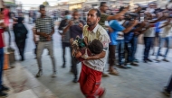 FILE PHOTO: A paramedic carries a wounded child by Israeli bombardment to the emergency ward at Nassr hospital in Khan Yunis, on the southern Gaza Strip on July 9, 2024. (Photo by Bashar Taleb / AFP)