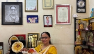 This photograph taken on May 31, 2025 shows Indian lawyer, activist and now International Booker Prize winner Banu Mushtaq posing with the book 'Heart Lamp' at her residence in Hassan, in India's Karnataka state. (Photo by Aishwarya Kumar / AFP)
