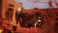 Responders search through building rubble following a strike by an Iranian missile in the Israeli city of Bat Yam, south of Tel Aviv, early on June 15, 2025. (Photo by Jack Guez / AFP)