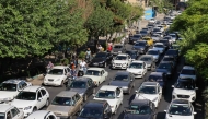 Vehicles await in traffic as people get out of Tehran through an artery in the city's west on June 15, 2025. (Photo by Atta Kenare / AFP)
 