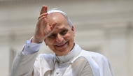 Pope Leo XIV waves to the crowd at the end of a weekly general audience at St Peter's Square in The Vatican on June 18, 2025. (Photo by Andreas SOLARO / AFP)
