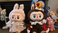 This picture taken on June 18, 2025 shows figures of the characters Mokoko (L) and Labubu in an exhibition room at Pop Mart's theme park Pop Land in Beijing. Photo by Pedro PARDO / AFP