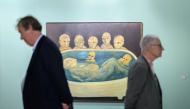 Visitors stand next to 'Die Wachter, 1990/1', a work by Swiss artist Annette Barcelo, on display at the Unlimited section of the Art Basel modern and contemporary art fair in Basel, on June 17, 2025. Photo by Fabrice COFFRINI / AFP.
