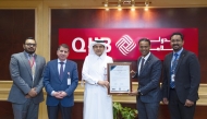 CEO of QIIB Dr. Abdulbasit Ahmed Al-Shaibei with other officials receiving the certification at the bank's headquarters at Grand Hamad Street.