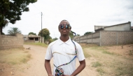 Robotics student and inventor Joao Antonio Rego (24) walks while wearing a smart glass prototype in Matola on June 14, 2025. (Photo by Amilton Neves / AFP)