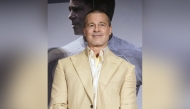 This photo taken on June 25, 2025 shows US actor Brad Pitt smiling on stage as he attends an event for his latest film 