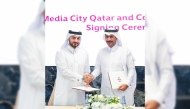CEO of Media City Qatar Eng. Jassim Mohamed Al Khori with an official of Commercial Bank during the agreement signing. 
