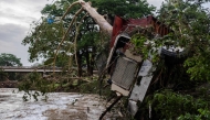  A large truck is impaled onto a tree after flash flooding on the bank Guadalupe River on July 5, 2025 in Center Point, Texas.
(Photo by Jim Vondruska / GETTY IMAGES NORTH AMERICA / Getty Images via AFP)