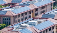 Solar panels installed on the tiled rooftops of buildings in San Francisco bay area, Silicon Valley in California, US.