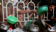 Palestinians shove to receive a hot meal at a charity kitchen in the Mawasi area of Khan Yunis in the southern Gaza Strip on July 22, 2025. Photo by AFP