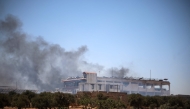 A plume of smoke rises following an explosion in Maarrat Misrin in the northern part of Syria's Idlib governorate on July 24, 2025. (Photo by Abdulaziz KETAZ / AFP)
