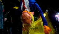 A person holds a dummy depicting US President Donald Trump during a protest in defense of national sovereignty after trade tariffs and sanctions were imposed by the US government on Brazil, near the US consulate in Rio de Janeiro, Brazil on August 1, 2025. (Photo by Mauro PIMENTEL / AFP)
